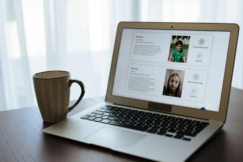 a laptop computer sitting on top of a wooden table, a picture, by Emma Andijewska, trending on unsplash, your personal data avatar, with full descriptions, family friendly, on a white table