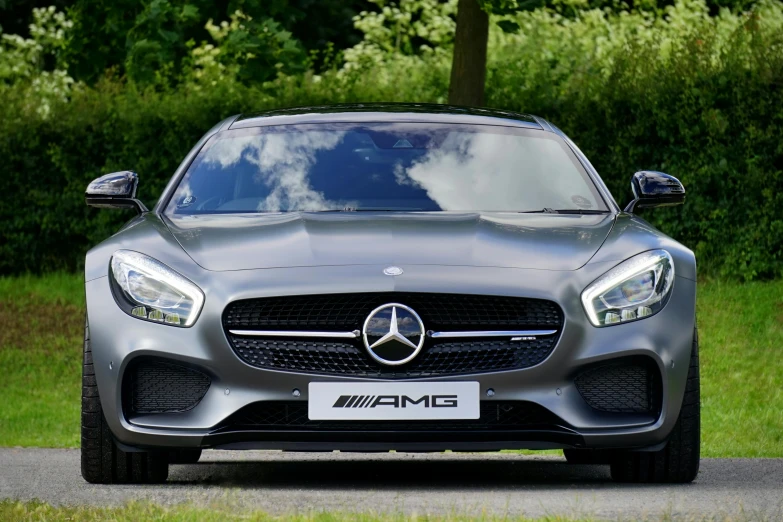 the mercedes amg gt is parked on the side of the road, by Tom Bonson, pexels contest winner, photorealism, front, grey metal body, full colour, thumbnail