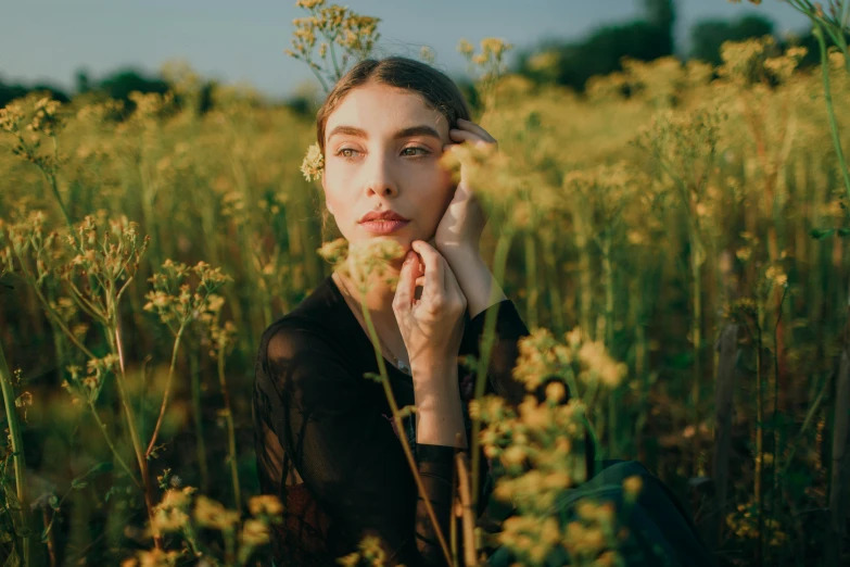 a woman sitting in a field of yellow flowers, inspired by Elsa Bleda, trending on pexels, with high cheekbones, portrait sophie mudd, woman made of plants, glossy skin