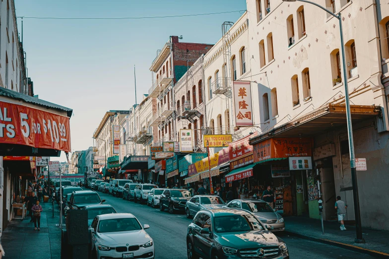 a street filled with lots of traffic next to tall buildings, trending on unsplash, cloisonnism, china town, california, cars parked underneath, walton's five and dime