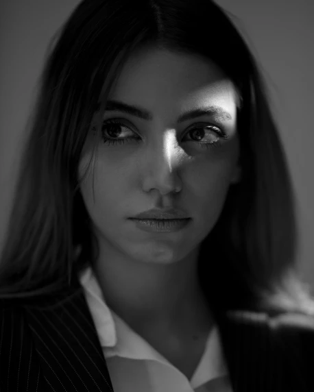 a black and white photo of a woman, inspired by irakli nadar, suit ， perfect face, 8k 50mm iso 10, 🤤 girl portrait, beautiful light big eyes