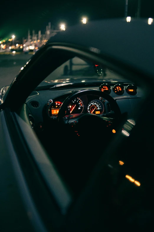 a car driving down a city street at night, pexels contest winner, high end interior, gauges, close portrait, drifting