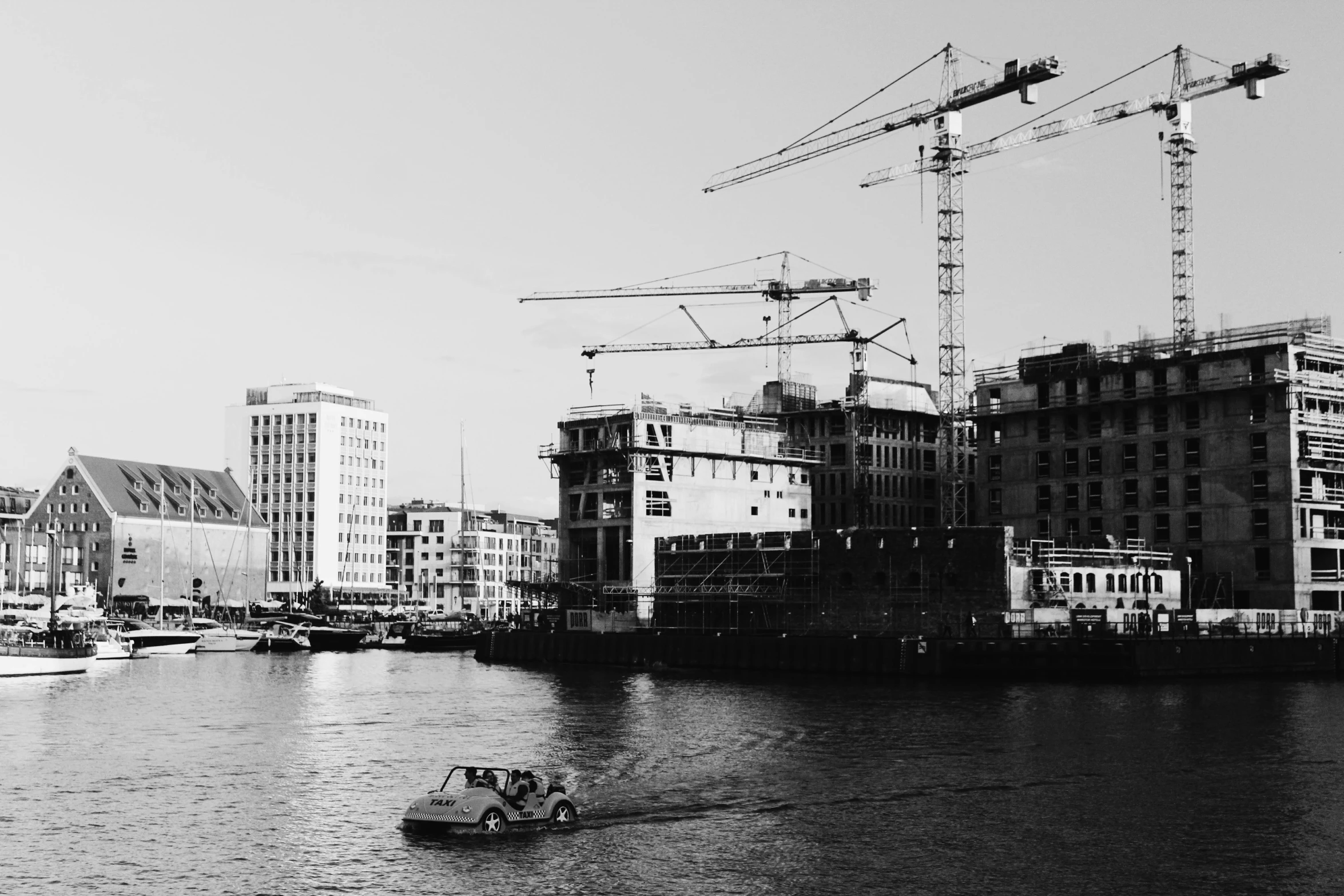 a black and white photo of a boat in the water, inspired by Thomas Struth, unsplash, constructivism, construction site, bjarke ingels, palast der republik in berlin, crane