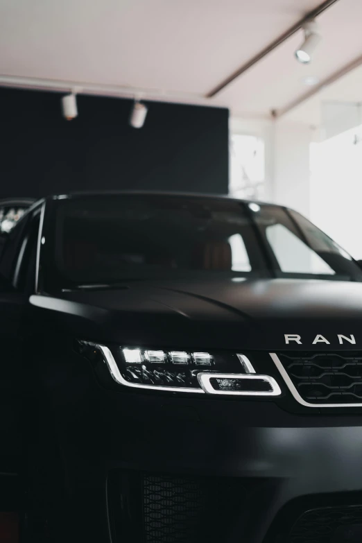 a black range rover parked in a garage, pexels contest winner, panoramic anamorphic, rayonism light effects and bokeh, vantablack gi, concert