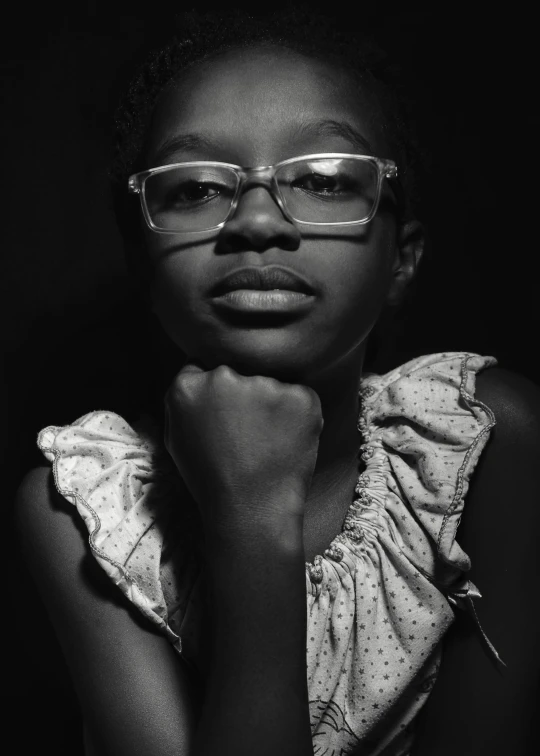 a black and white photo of a woman with glasses, inspired by Gordon Parks, young girl, nerdy black girl super hero, taken in 2 0 2 0, small square glasses