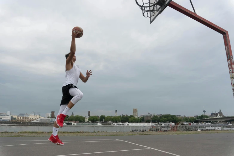 a man that is jumping in the air with a basketball, 15081959 21121991 01012000 4k, on the concrete ground, portrait of tall, crane shot