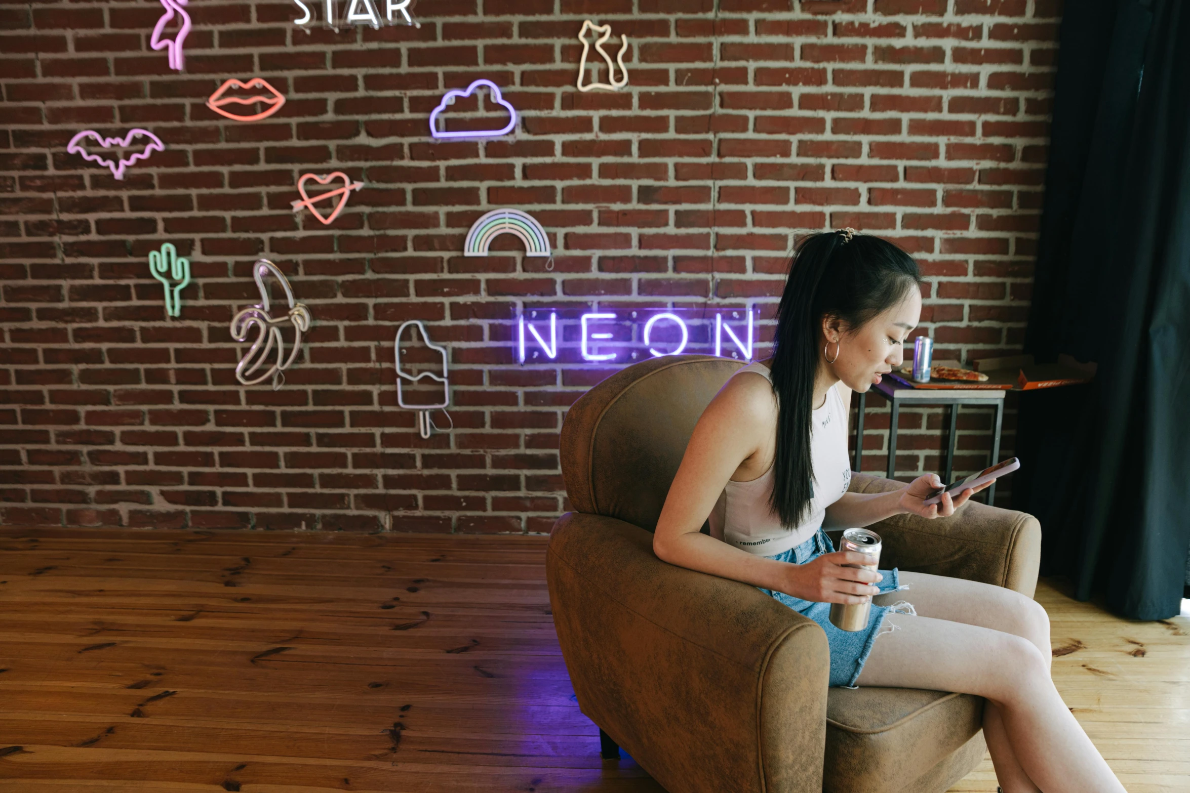 a woman sitting in a chair using a cell phone, trending on pexels, neo-figurative, some have neon signs, android coffee shop, beautiful space star planet neon, an asian woman