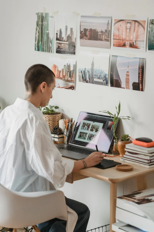 a man sitting at a desk using a laptop computer, a picture, pexels contest winner, arbeitsrat für kunst, apartment of an art student, profile image, avatar image, instagram picture