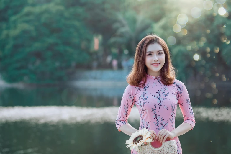 a woman standing in front of a lake holding a basket, inspired by Tan Ting-pho, pexels contest winner, wearing pink floral gown, girl cute-fine-face, phong shaded, teenage girl