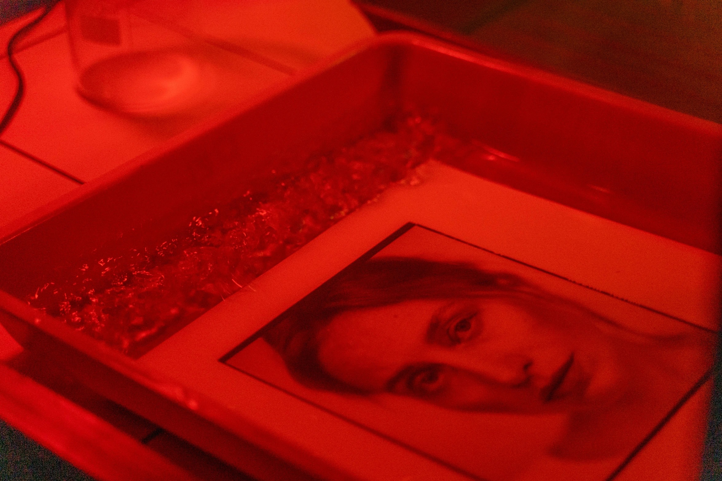 a box with a picture of a woman in it, pexels, process art, red led lights, in a red dish, bio-luminescence, gelatin silver process