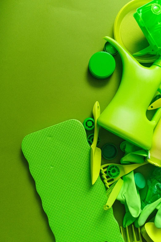 a bunch of green items sitting on top of a table, inspired by Art Green, trending on pexels, plasticien, flourescent colors, hdpe, profile pic, vibrant patterns