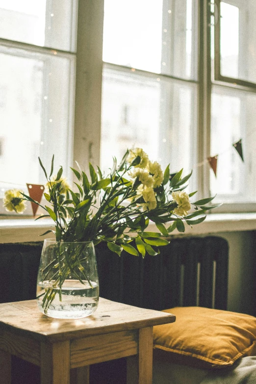 a vase of flowers sitting on a table in front of a window, trending on unsplash, arts and crafts movement, cozy cafe background, hazy and dreary, celebration, floating bouquets