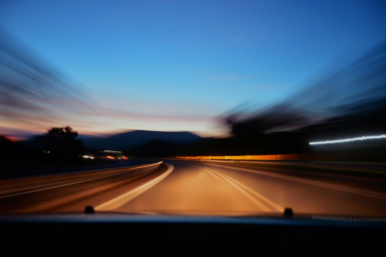 a blurry photo of a highway at night, by Carey Morris, unsplash, inside of a car, afternoon, getty images, low horizon