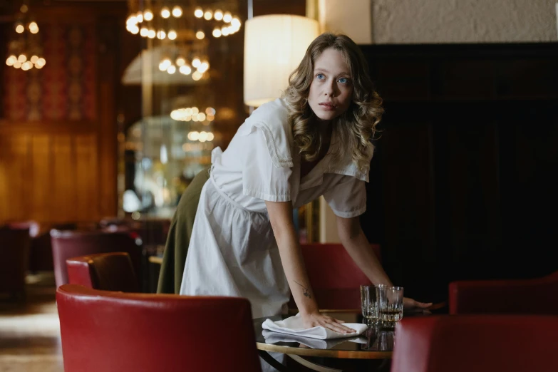 a woman is setting a table in a restaurant, a portrait, by Emma Andijewska, pexels contest winner, happening, sydney sweeney, wearing maid uniform, cinema still, hunting