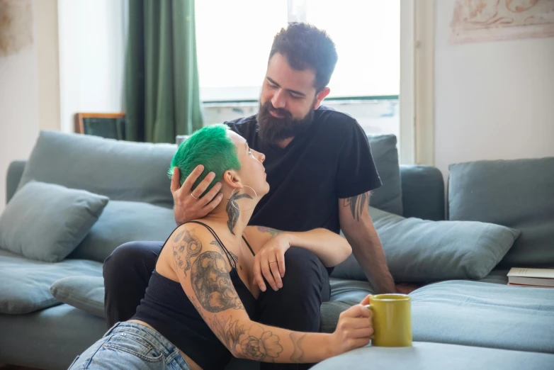 a man and a woman sitting on a couch, a tattoo, inspired by Elsa Bleda, pexels contest winner, renaissance, short unkempt green hair, morning coffee, lgbt, youtube thumbnail