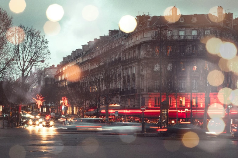 a city street filled with lots of traffic next to tall buildings, a photo, by Daniel Gelon, visual art, parisian street at night, overcast bokeh, splendid haussmann architecture, illustration”