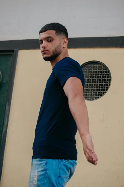 a man riding a skateboard down a street, an album cover, pexels contest winner, renaissance, blue tight tshirt, navy-blue, thoughtful pose, profile image