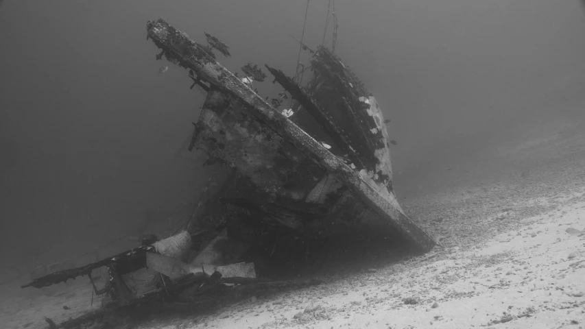 a black and white photo of a boat in the water, standing in a space ship wreck, dust mist, red sea, sea queen