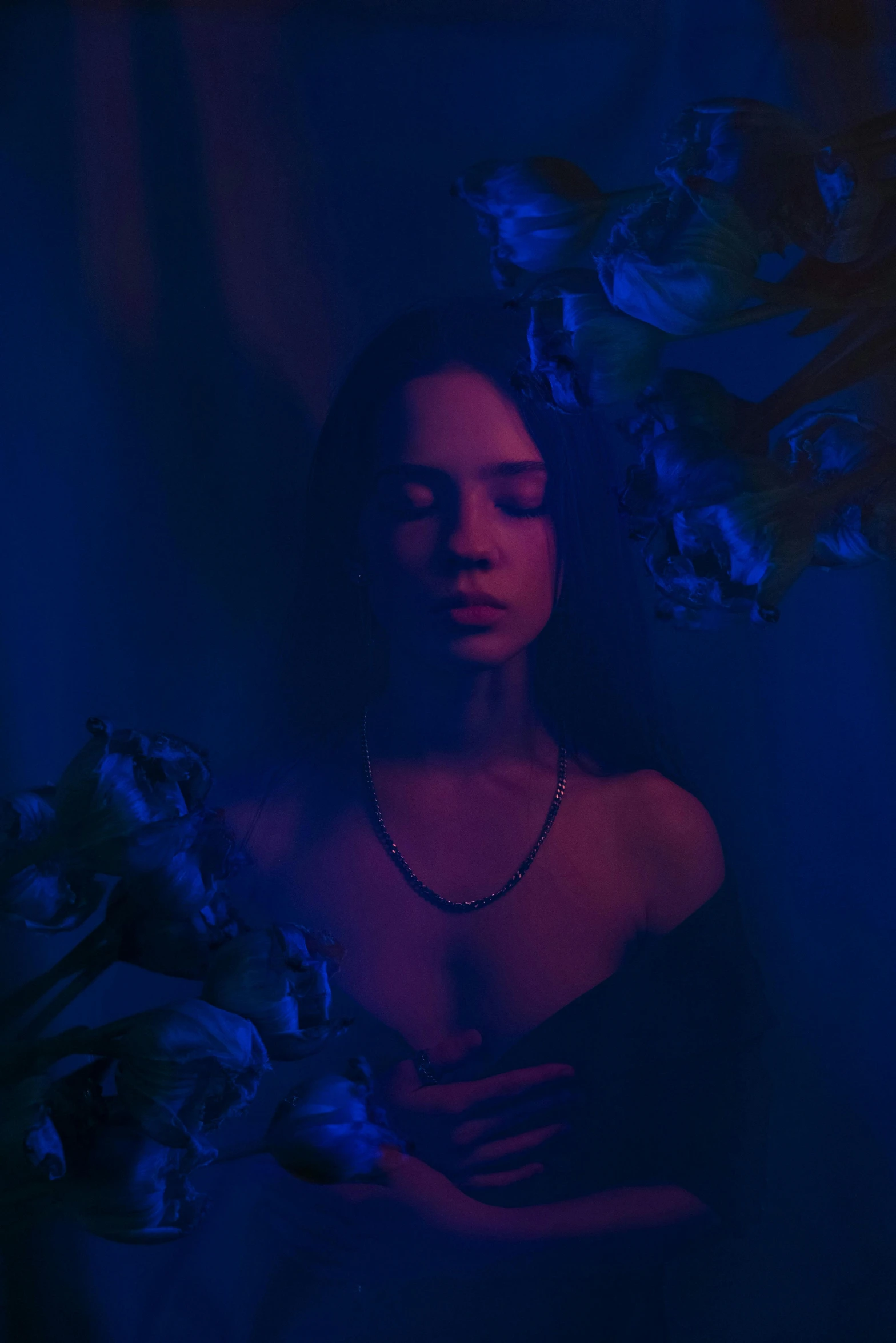 a woman in a black dress holding a bouquet of flowers, an album cover, inspired by Elsa Bleda, pexels contest winner, blue scales covering her chest, tessa thompson inspired, anna nikonova aka newmilky, purple dim light