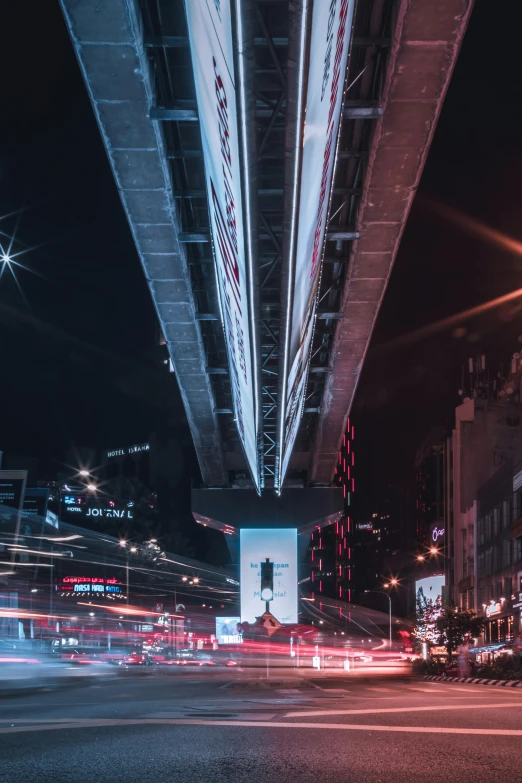 a city street filled with lots of traffic at night, unsplash contest winner, digital art, sky bridges, billboard image, seen from below, new york city