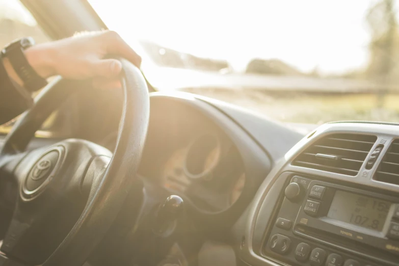 a close up of a person driving a car, square, premium, touring, natural morning light