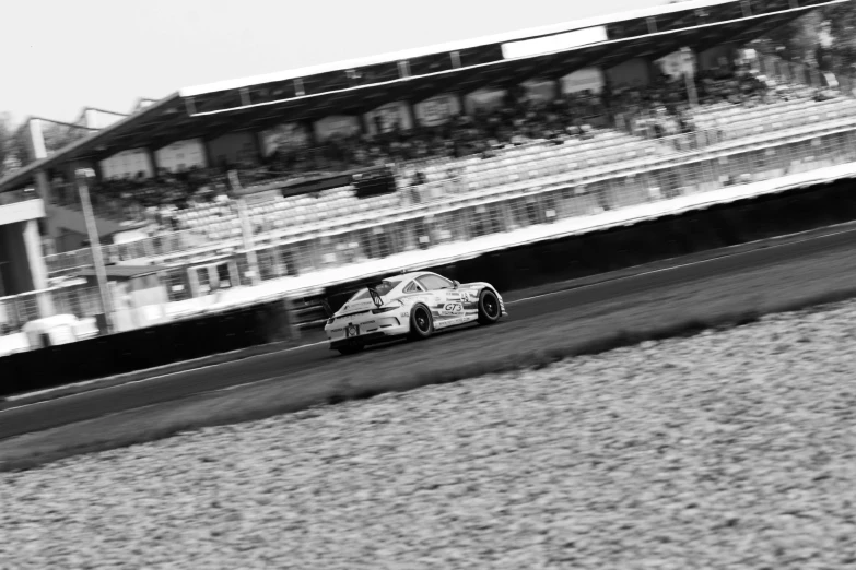 a black and white photo of a racing car, a tilt shift photo, by Hasegawa Settan, shin hanga, the atmosphere is cheerful, race footage, phone photo, corner