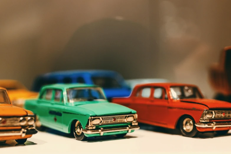 a group of toy cars sitting on top of a table, pexels contest winner, photorealism, moskvich, brightly lit, instagram picture, in retro colors