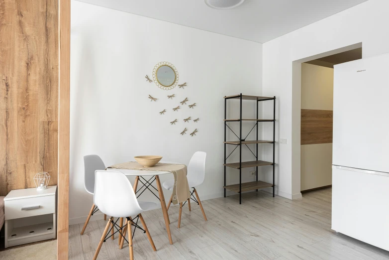 a white refrigerator freezer sitting inside of a kitchen, a photo, by Adam Marczyński, pexels contest winner, light and space, dining table, white background wall, flat grey color, small and cosy student bedroom