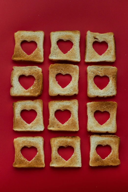 heart shaped pieces of toast on a red surface, trending on pexels, squares, brown holes, blond, artoast8p