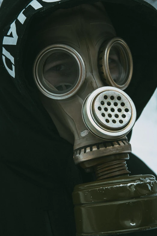 a man wearing a gas mask and a hood, an album cover, by Adam Marczyński, pexels contest winner, full body extreme closeup, clear [[bronze]] face [mask], air pollution, historical