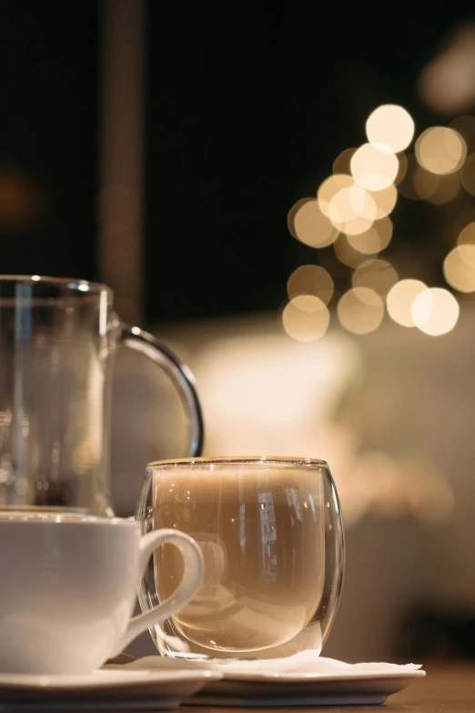 a close up of a cup of coffee on a table, glass and lights, silver，ivory, zoomed in, medium - shot