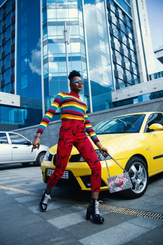 a woman standing in front of a yellow car, trending on pexels, afrofuturism, rainbow stripe backdrop, taxis, street wear, red car