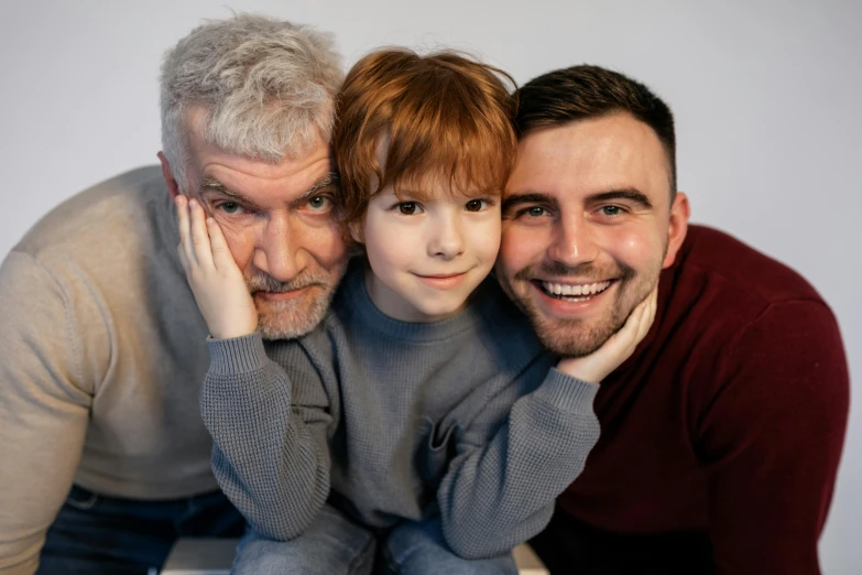 a man and two boys posing for a picture, gray beard, brunette boy and redhead boy, caring fatherly wide forehead, non-binary