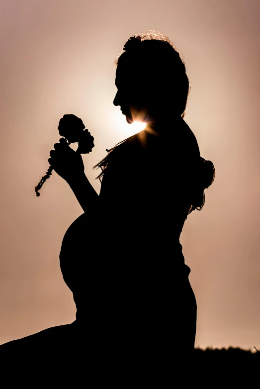 a silhouette of a pregnant woman holding a flower, by Matt Stewart, pixabay contest winner, backlit!!, kara walker, photo pinterest, instrument