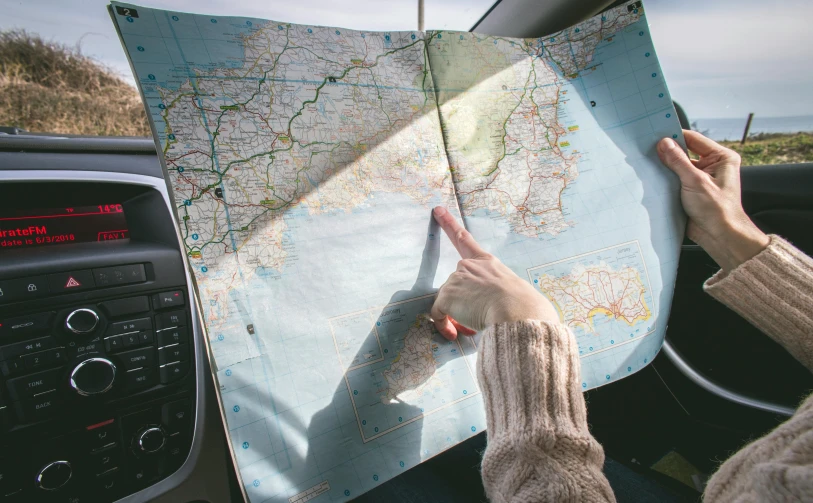 a person holding a map in a car, flatlay, cornwall, fan favorite, panels