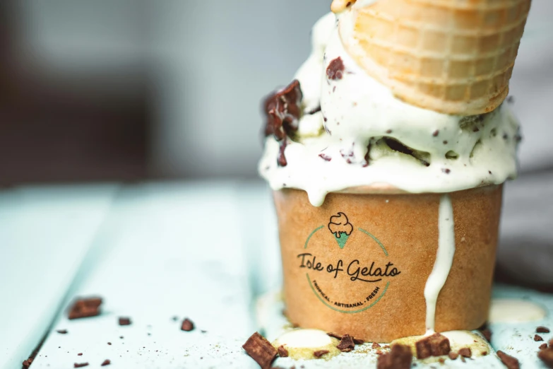 an ice cream cone sitting on top of a table, gilleard, background image, glasgow, closeup at the food