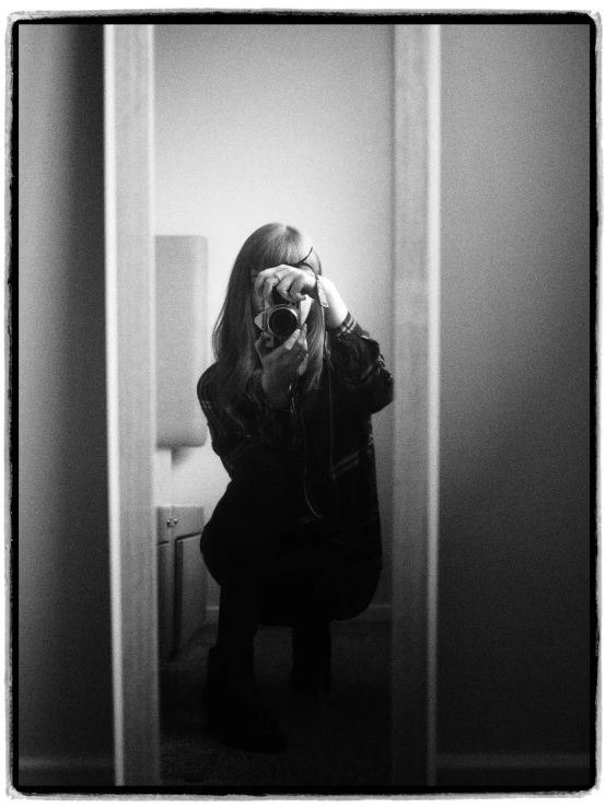 a woman taking a picture of herself in a mirror, a black and white photo, by Christen Dalsgaard, portrait!!!, ewa juszkiewicz, britt marling style, detailed medium format photo