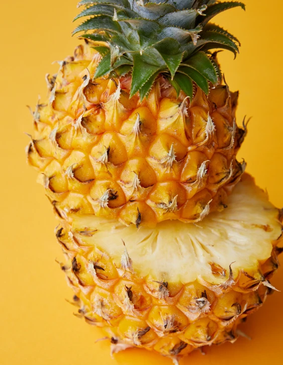 a pineapple cut in half on a yellow background, trending on unsplash, background image, multiple stories, sassy pose, lgbtq