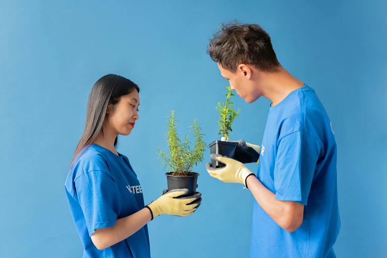 a man and a woman holding a potted plant, pexels contest winner, blue shirt, profile image, robotics, thumbnail