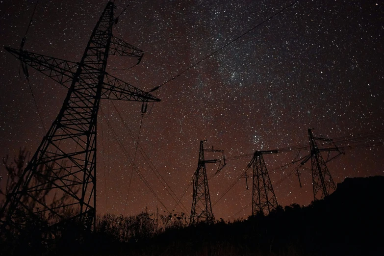 a sky filled with lots of stars next to power lines, renaissance, pylons, dark eerie photograph, getty images, **cinematic