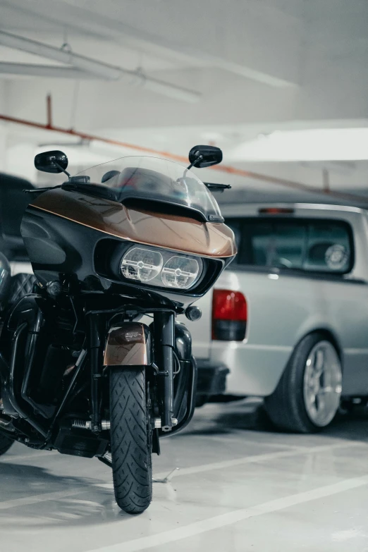 a motorcycle is parked in a parking garage, black car, shot with premium dslr camera, brown, 🚿🗝📝