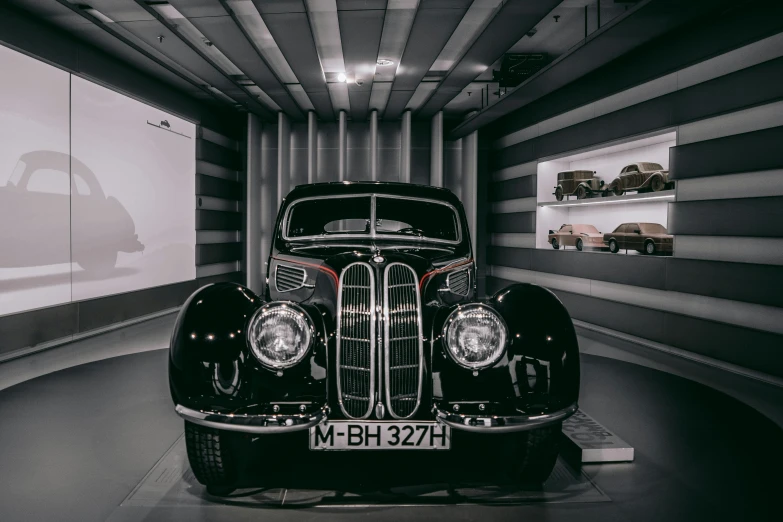 a black and white photo of a classic car, by Matthias Stom, pexels contest winner, bauhaus, on display in a museum, bmw, 15081959 21121991 01012000 4k, symmetrical front view