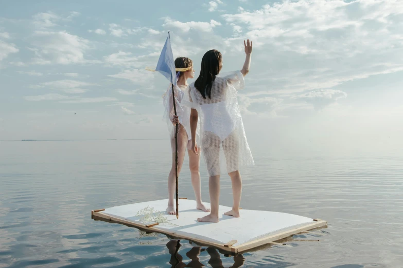 a couple of women standing on top of a floating platform, pexels contest winner, conceptual art, sail made of human skin, midsommar style, tansparent water, uniform off - white sky