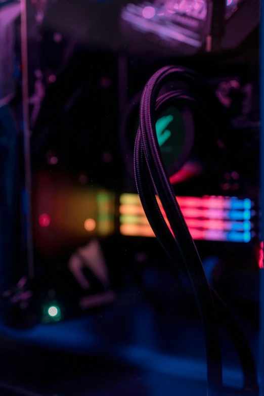 a close up of a computer case in a dark room, unsplash, colorful wires, blue and purple lighting, graphics card, red and green lighting