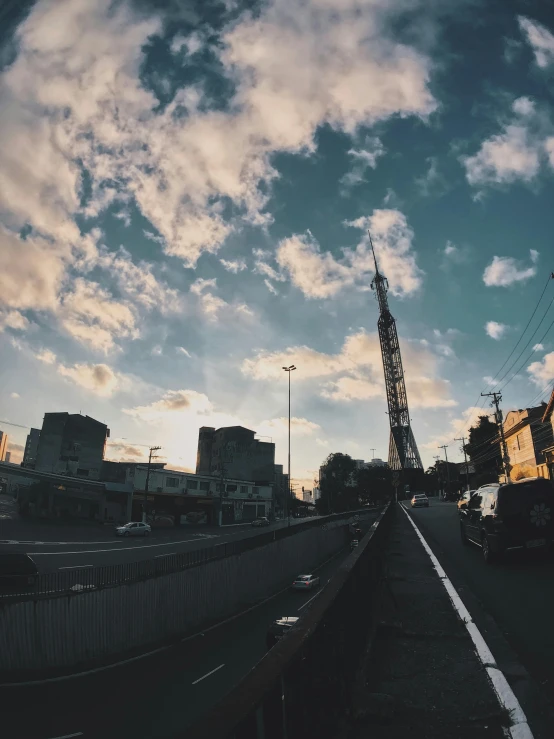 a train traveling down a train track under a cloudy sky, a picture, by Niko Henrichon, happening, tokyo street background, sitting in a crane, 🚿🗝📝, sky setting