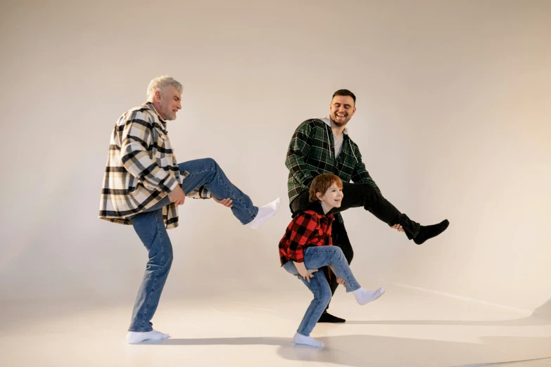 a couple of men standing next to a little girl, pexels, doing a kick, wearing a flannel shirt, owen gent, danny fox