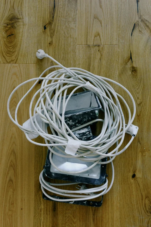 a pile of electronics sitting on top of a wooden floor, inspired by Sarah Lucas, flickr, satisfying cable management, digital image, mac, cracks
