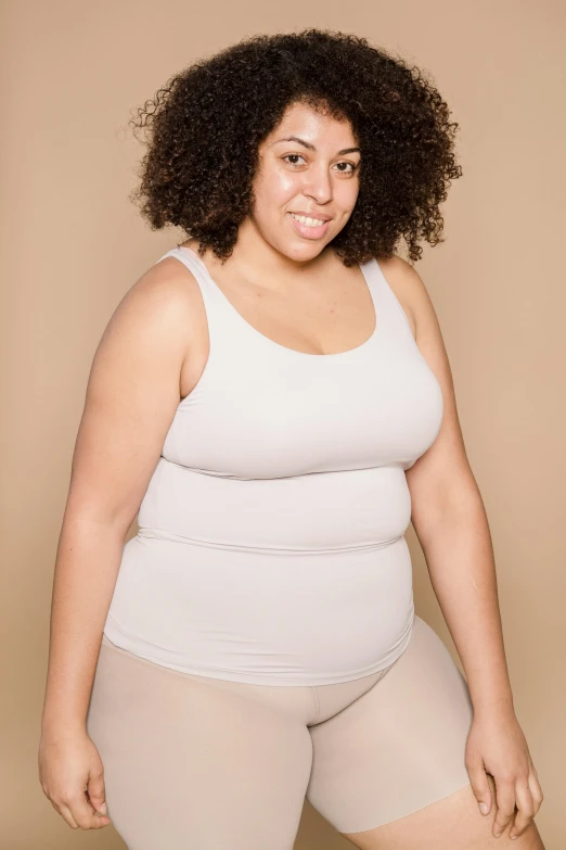 a woman in a white tank top and tan shorts, trending on pexels, obese ), with grey skin, portrait image, rebecca sugar