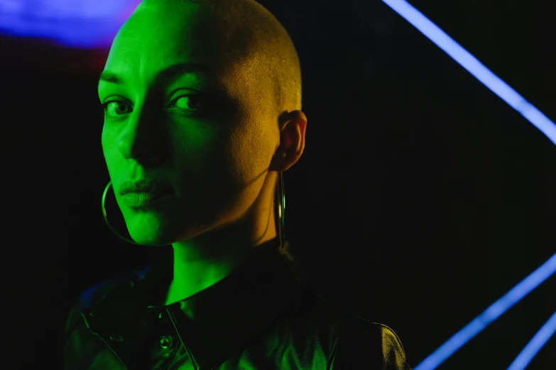 a close up of a person with a shaved head, an album cover, inspired by Elsa Bleda, pexels, antipodeans, vivid green lasers, portrait sophie mudd, all black cyberpunk clothes, bisexual lighting