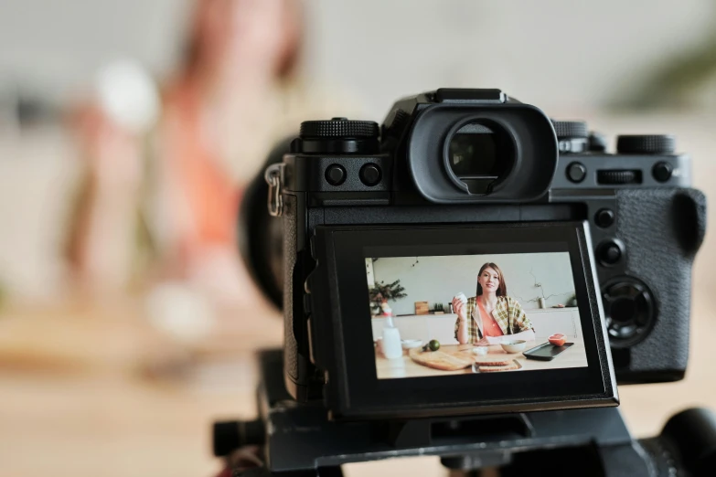 a close up of a camera on a tripod, by Julia Pishtar, trending on pexels, video art, cooking show, two models in the frame, everything fits on the screen, center focus on table